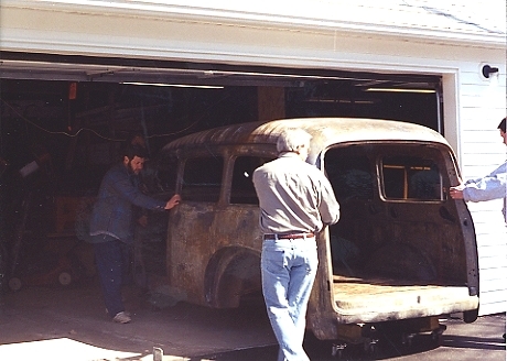 03PullItOut Roger, Brian, and Jason roll out the body on wheel dollies with 6x6 timbers.