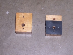 SubBodyMounts_7 Top (left) and bottom (right) of 
the wood blocks (4 needed).
Rubber pad tacked to block.
Two screw holes to attach block
to plate above it (with thin screw).
Mounting-bolt hole is off-center.