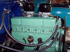  The distributur/coil/wires with 6v Pertronix ignition are not installed.  The distributor here has no cam gear and will be used to prime the engine with oil before starting.  A 0-5 psi fuel regulator is behind the water lines at the right of the block.
