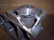 This photo shows the first part of the preparation of the part for spray-welding.  Mike Aldrich ground away material in a few mating locations of two p[ieces (middle bottom, in this photo).  This would allow Mike to 